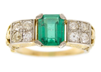 Lot 253 - An Art Deco 18ct (tested) diamond and synthetic emerald set dress ring.