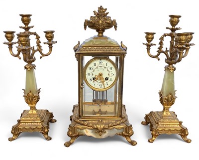 Lot 1642 - A French onyx and gilt bronze clock garniture