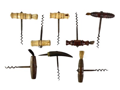 Lot 82 - A collection of bone and hardwood direct pull corkscrews with brushes.