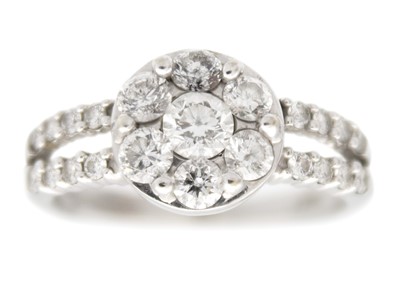 Lot 7 - A modern 14ct white gold diamond cluster dress ring.