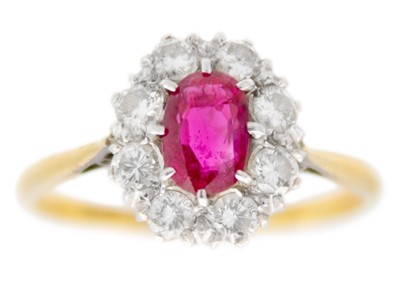 Lot 168 - An 18ct and platinum ruby and diamond set cluster ring.