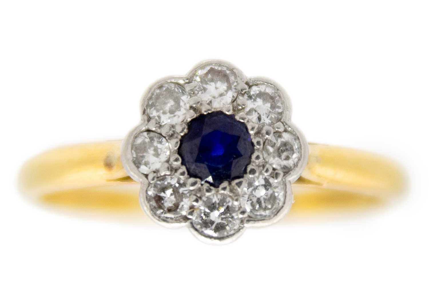 Lot 202 - An 18ct diamond and blue sapphire set daisy