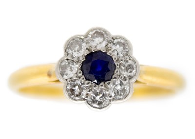 Lot 202 - An 18ct diamond and blue sapphire set daisy cluster ring.