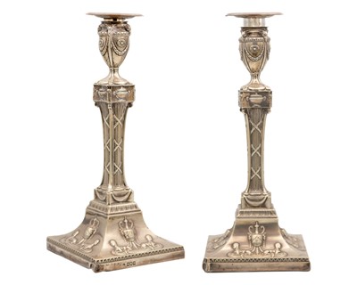 Lot 74 - An Edwardian silver good pair of Neo-Classical style candlesticks by William Comyns.