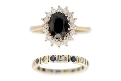 Lot 230 - A 9ct blue and white sapphire cluster ring and a 9ct sapphire set full eternity ring.