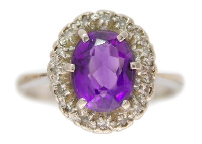 Lot 248 - An 18ct white gold amethyst and diamond set cluster ring.