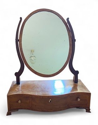 Lot 888 - A late George III mahogany oval swing toilet mirror.