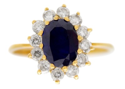 Lot 206 - An 18ct diamond and blue sapphire set cluster ring.