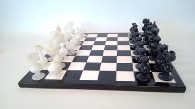 Lot 13 - A marble chess board and pieces, all pieces...