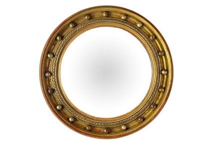 Lot 310 - A Regency style circular gilt convex wall mirror.