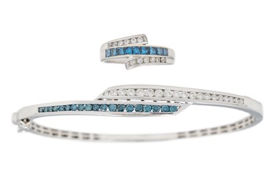 Lot 44 - A modern 14ct white gold, white and blue diamond set, hinged bangle and matching ring.