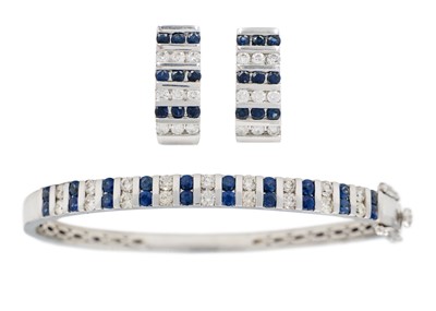 Lot 42 - A  good modern 14ct white gold diamond and sapphire set hinged bangle with matching earrings.