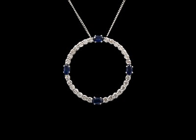 Lot 179 - A white gold (tested 14ct) diamond and sapphire set annular pendant.