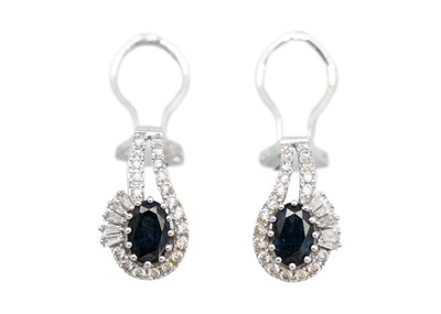 Lot 181 - A pair of 14ct white gold diamond and sapphire set earrings.