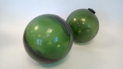 Lot 298 - Three vintage glass fishing floats, each 13cm...