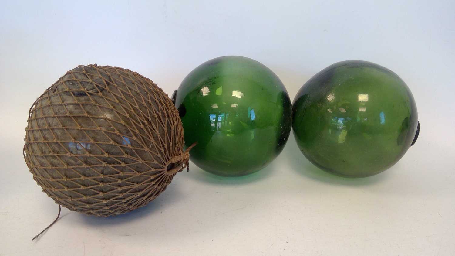 Lot 298 - Three vintage glass fishing floats, each 13cm...