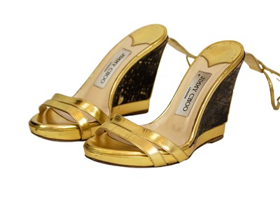 Lot 352 - JIMMY CHOO - A pair of gold leather espadrille wedges.