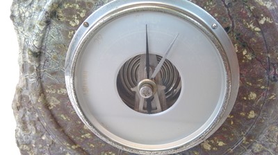 Lot 11 - A Serpentine barometer, height 20cm.