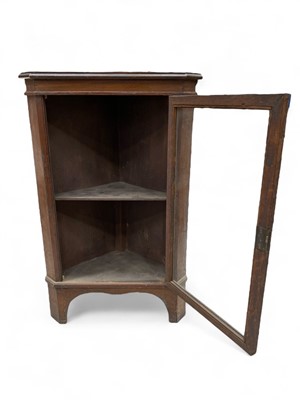 Lot 8 - A glazed oak standing corner cupboard