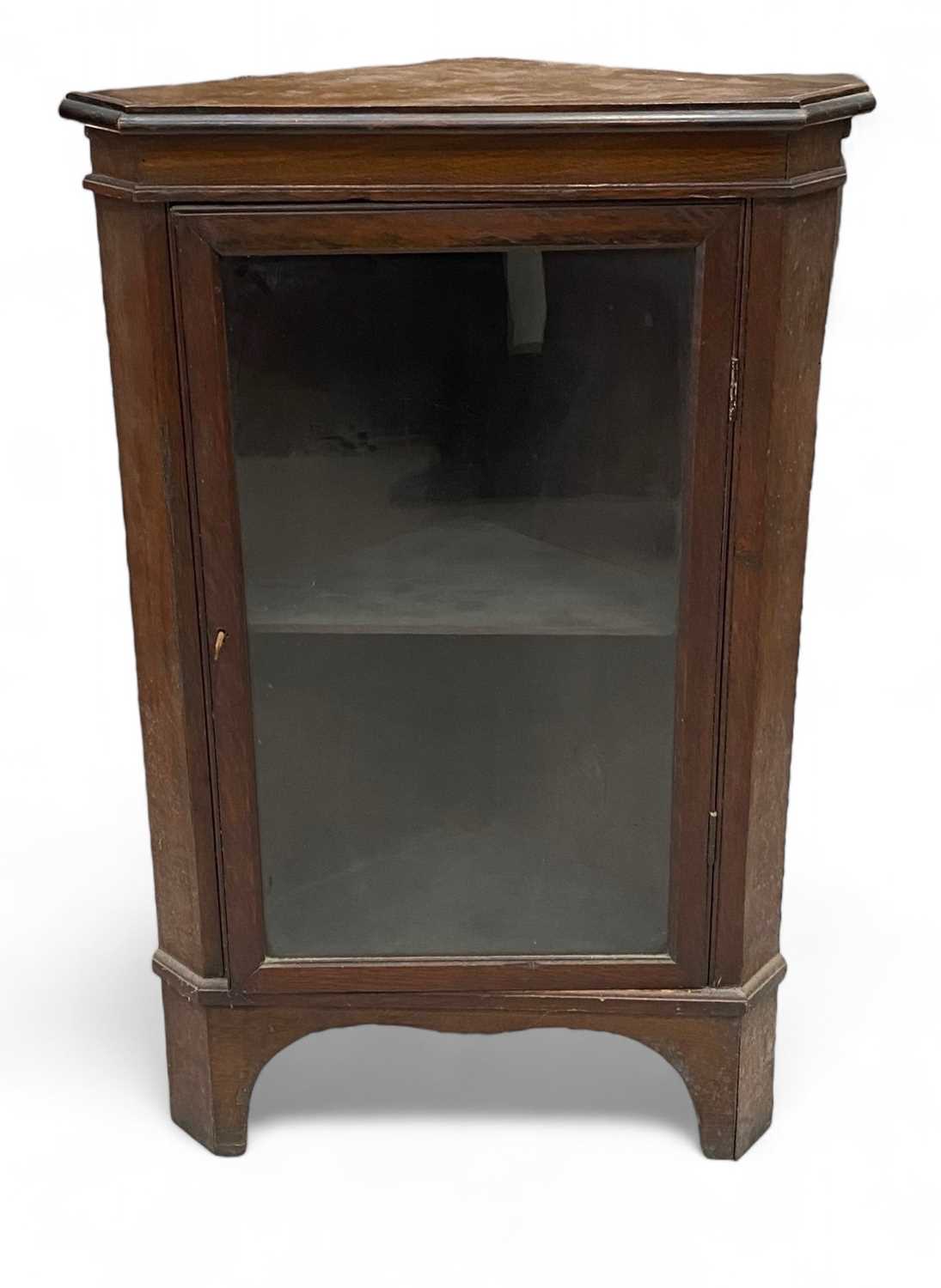 Lot 8 - A glazed oak standing corner cupboard