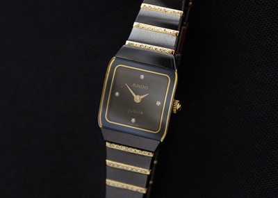 Lot 140 - RADO - A Jubile Diamond Star lady's black ceramic and gold-plated quartz bracelet wristwatch.