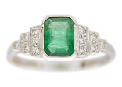 Lot 228 - A modern Art Deco style 9ct white gold emerald & diamond set dress ring.