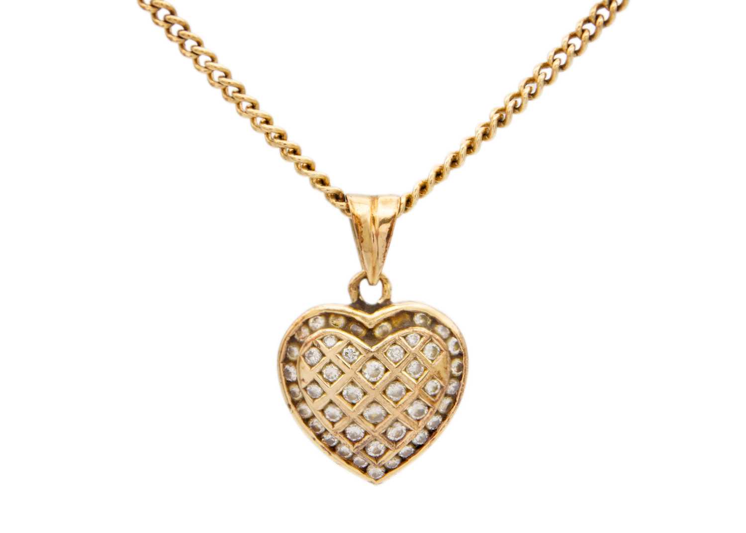 Lot 14 - A 9ct diamond set heart pendant on a 9ct curb link chain.