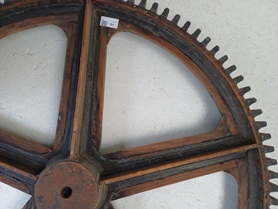 Lot 51 - A large painted wood and pine cog pattern.