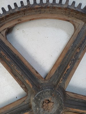 Lot 51 - A large painted wood and pine cog pattern.