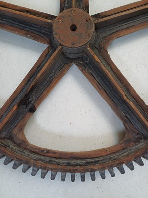 Lot 51 - A large painted wood and pine cog pattern.