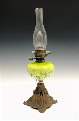 Lot 156 - An early 20th century oil lamp, the green...