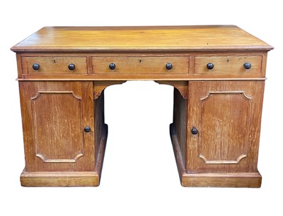 Lot 936 - A late Victorian pine kneehole desk.