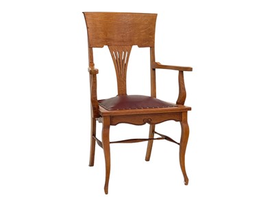 Lot 922 - An oak office elbow chair.