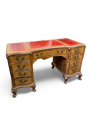 Lot 973 - A free-standing kneehole desk. 20th century