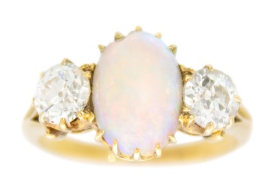 Lot 19 - An 18ct diamond and white opal set three-stone ring.