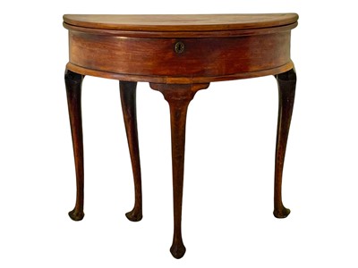 Lot 995 - A George II mahogany demi lune fold top tea table.