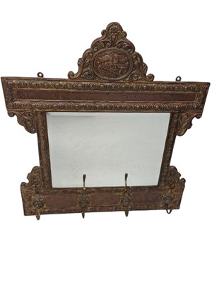 Lot 104 - A Low Countries stamped brass wall mirror/coat hook.