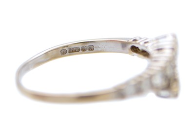 Lot 86 - A modern 18ct white gold diamond set twelve stone crossover style ring.