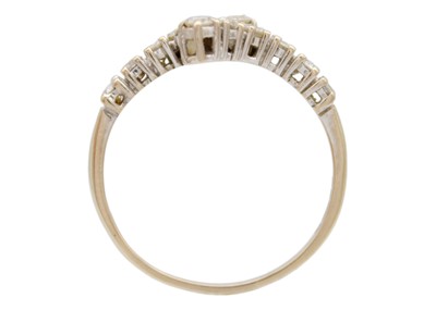 Lot 86 - A modern 18ct white gold diamond set twelve stone crossover style ring.