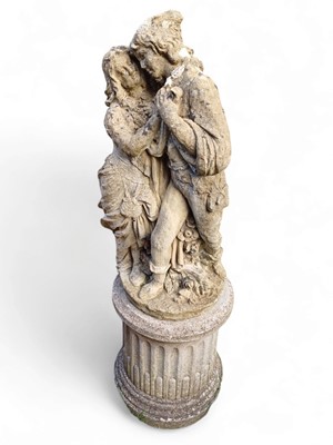 Lot 832 - A reconstituted stone figure group of an amorous couple.