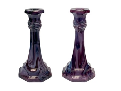 Lot 585 - A pair of Davidson purple cloud pressed glass octagonal candlesticks.