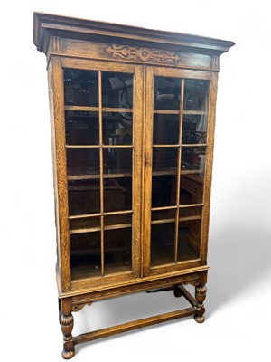 Lot 934 - A glazed oak bookcase.