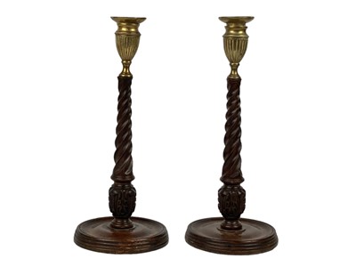 Lot 304 - A pair of 19th century mahogany brass mounted candlesticks.