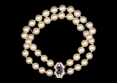 Lot 209 - A double row cultured pearl bracelet with 18ct diamond and sapphire set clasp.