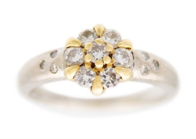 Lot 104 - An 18ct yellow and white gold diamond set cluster ring.