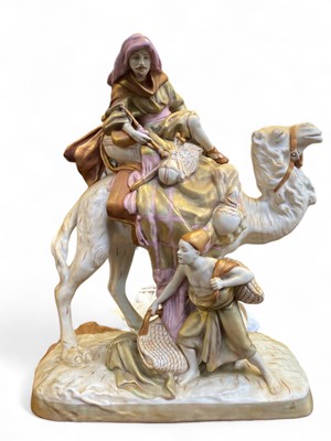 Lot 565 - A Royal Dux porcelain figure group of a camel rider.