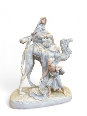 Lot 566 - A Royal Dux porcelain figure group of a camel rider.