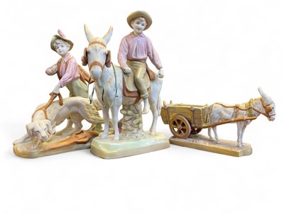 Lot 567 - A Royal Dux porcelain figure group of a boy riding a donkey.