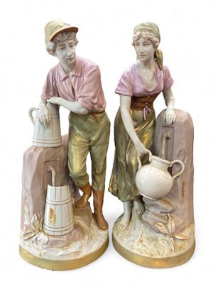 Lot 568 - A large pair of Royal Dux porcelain figures of water carriers.