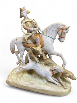 Lot 570 - A large Royal Dux porcelain figure group of a hunter on horseback with hounds.